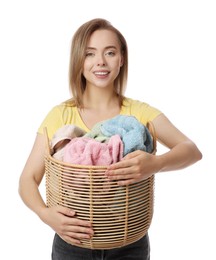 Photo of Happy young housewife with basket full of laundry on white background