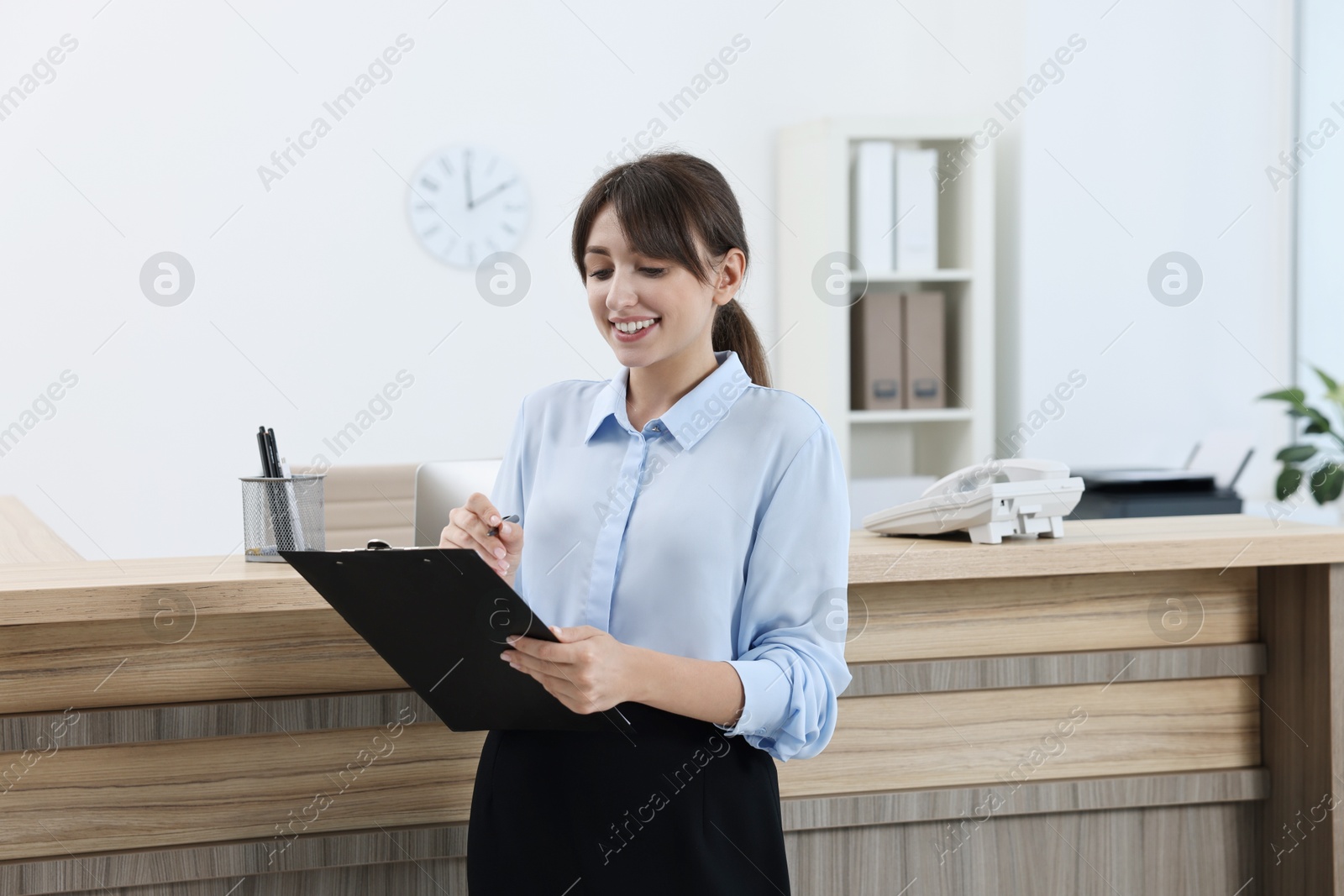 Photo of Portrait of professional receptionist in modern office