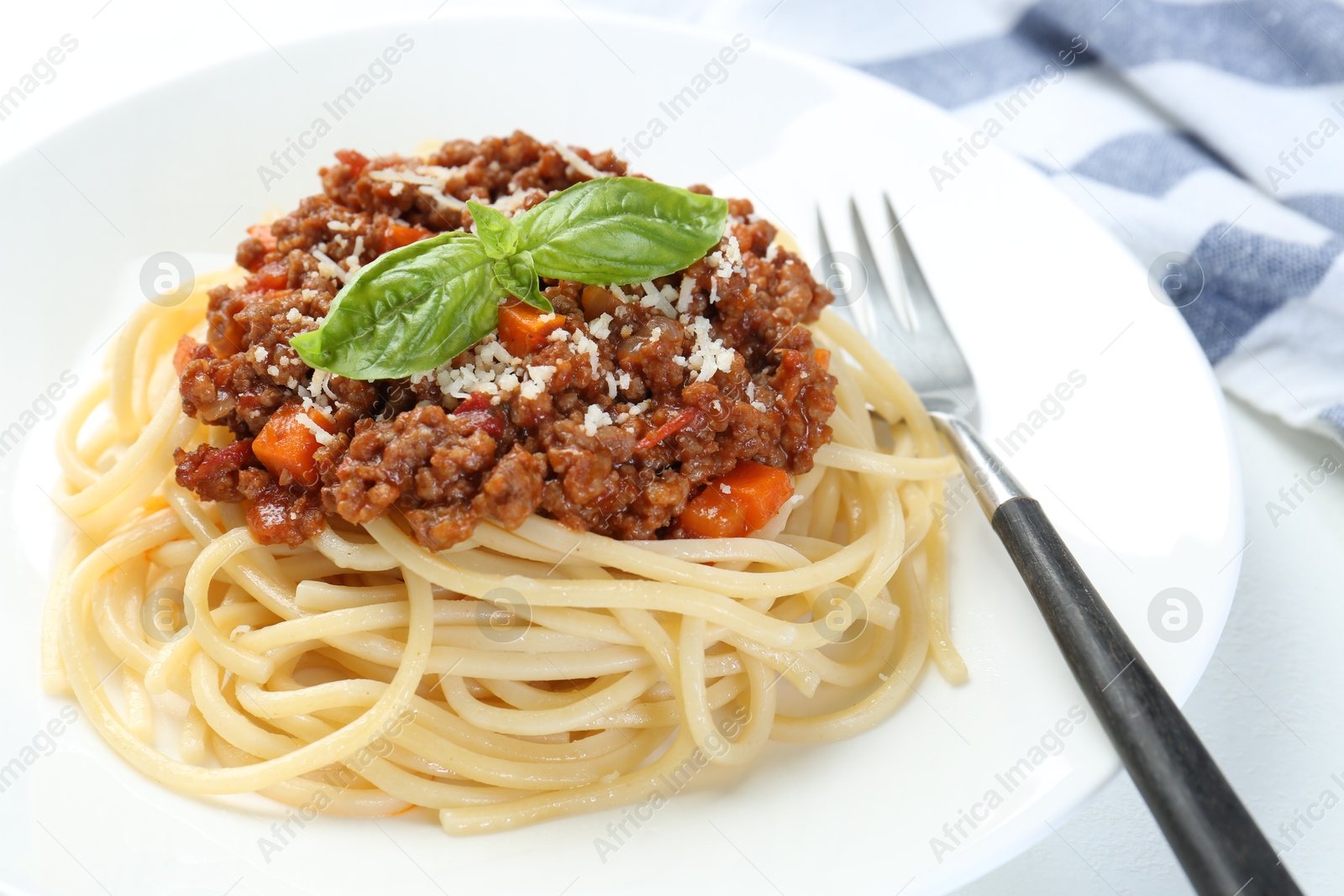 Photo of Tasty pasta bolognese on white table, closeup