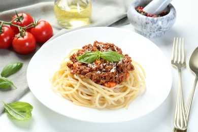 Photo of Delicious pasta bolognese served on white table