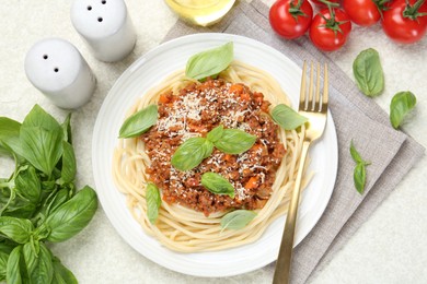 Delicious pasta bolognese served on light table, flat lay