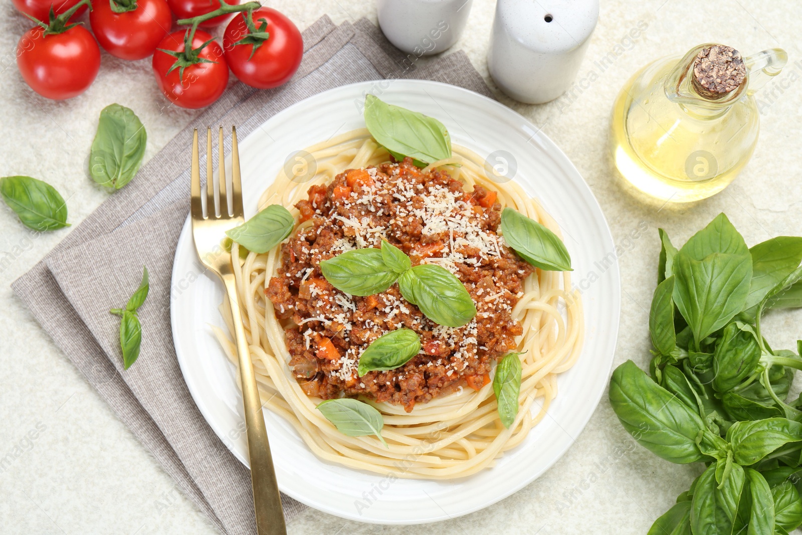 Photo of Delicious pasta bolognese served on light table, flat lay