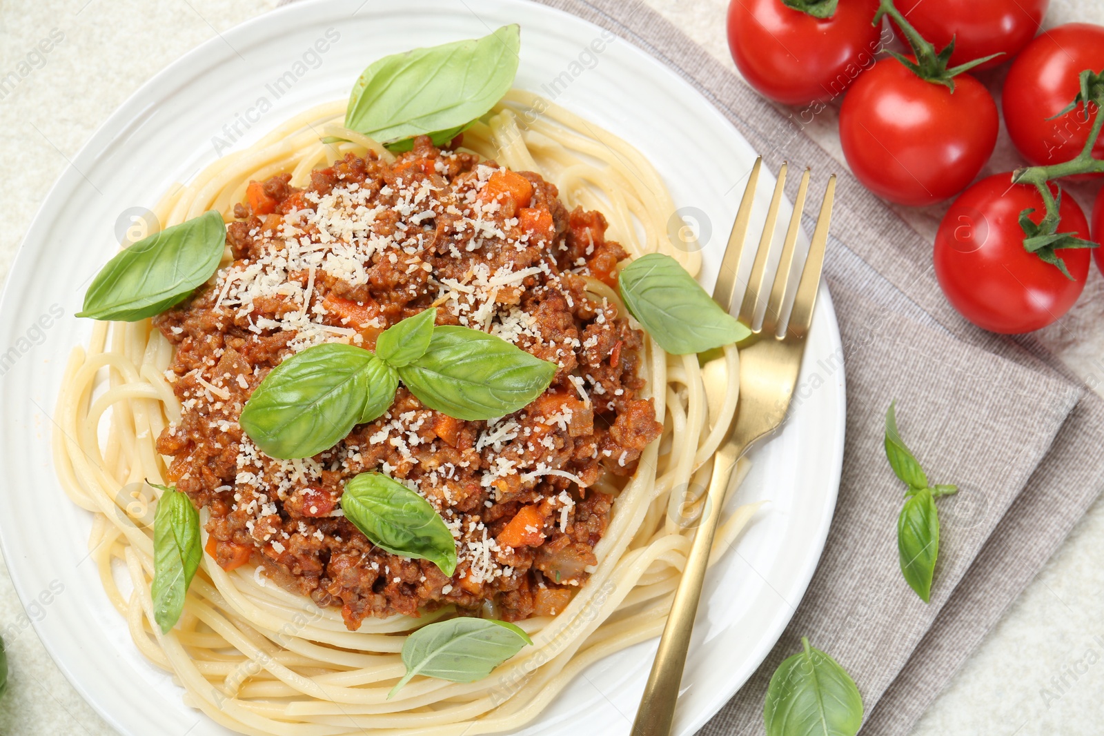 Photo of Delicious pasta bolognese served on light table, flat lay