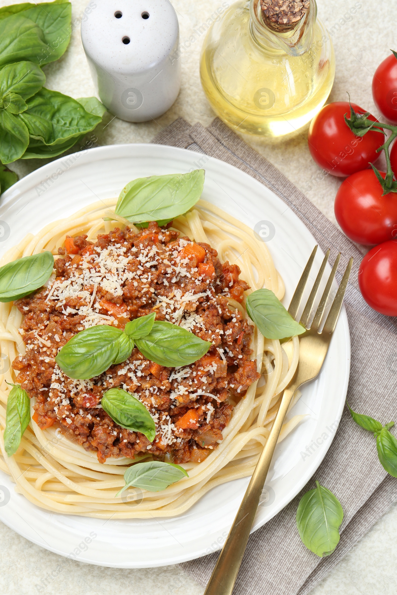 Photo of Delicious pasta bolognese served on light table, flat lay