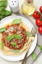 Photo of Delicious pasta bolognese served on light table, flat lay