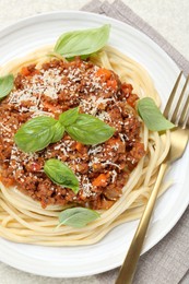 Delicious pasta bolognese served on light table, flat lay