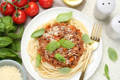 Photo of Delicious pasta bolognese served on light table, flat lay