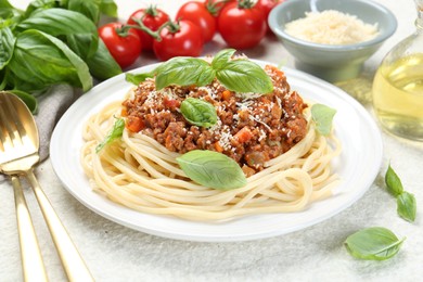 Photo of Tasty pasta bolognese served on white table, closeup