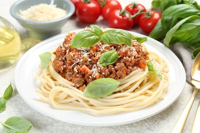 Tasty pasta bolognese served on white table, closeup