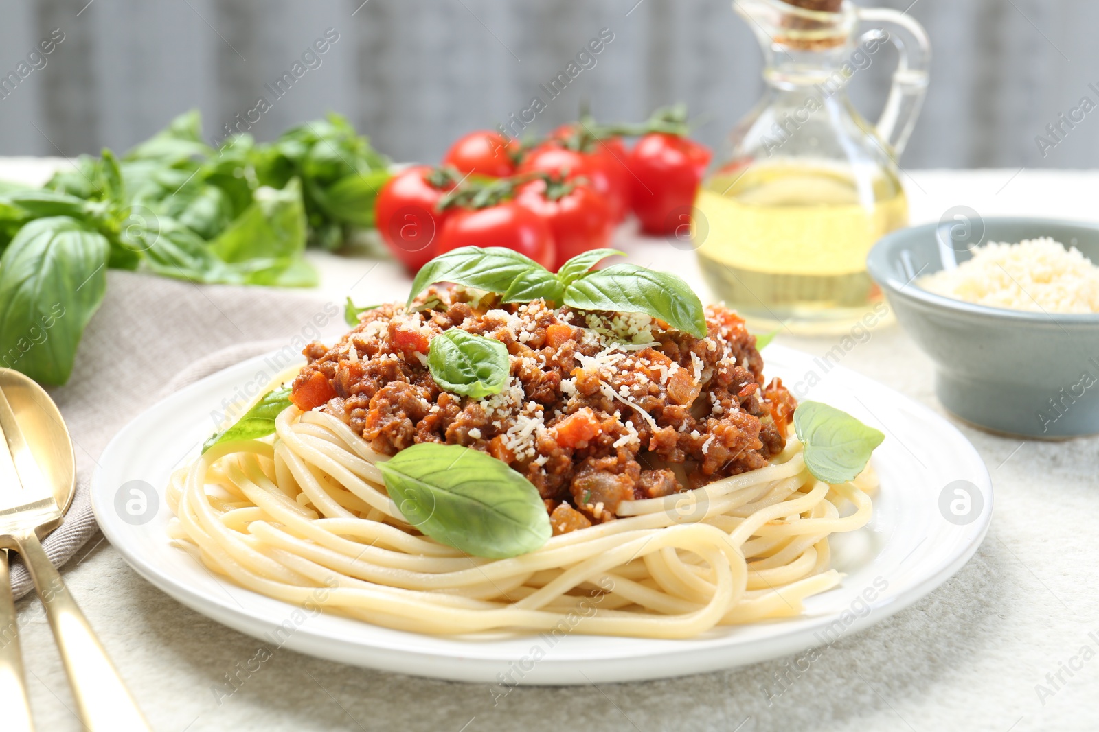 Photo of Tasty pasta bolognese served on white table, closeup