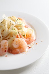 Photo of Delicious pasta with shrimps and cheese on white table, closeup