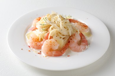 Photo of Delicious pasta with shrimps and cheese on white table, closeup