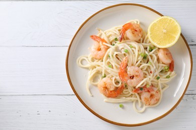 Photo of Delicious pasta with shrimps and green onion on white wooden table, top view. Space for text