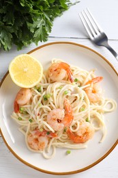 Photo of Delicious pasta with shrimps, green onion and parsley on white wooden table, top view