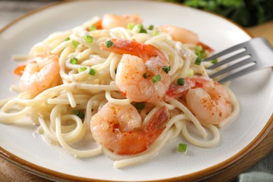 Photo of Delicious pasta with shrimps and green onions on table, closeup