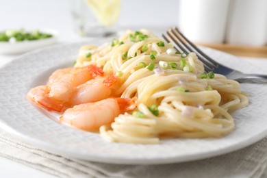 Photo of Delicious pasta with shrimps and green onions on table, closeup