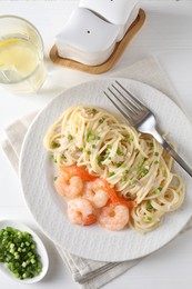 Photo of Delicious pasta with shrimps served on white wooden table, top view