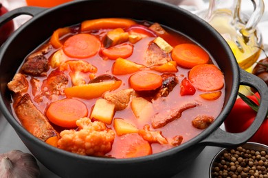 Photo of Tasty homemade stew with vegetables on table, closeup