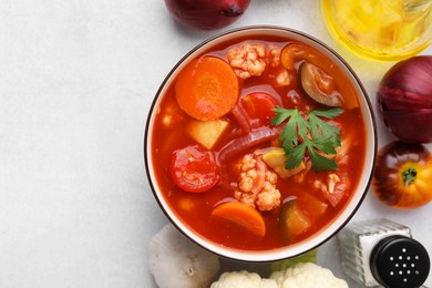 Photo of Tasty homemade stew with vegetables on white table, flat lay. Space for text