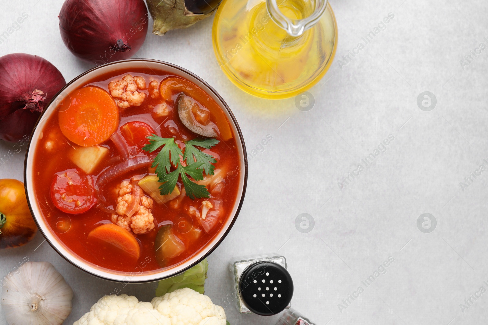 Photo of Tasty homemade stew with vegetables on white table, flat lay. Space for text