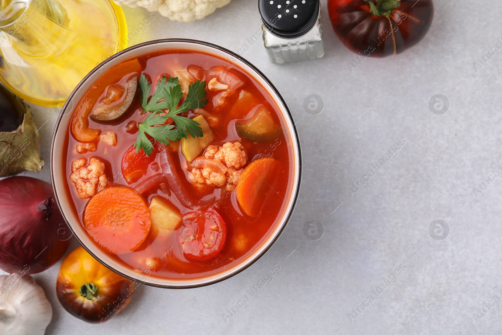 Photo of Tasty homemade stew with vegetables on white table, flat lay. Space for text