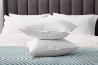 Many soft pillows on bed at home