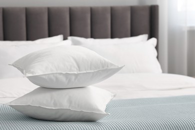 Many soft pillows on bed at home