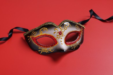 Photo of One beautiful carnival mask on red background