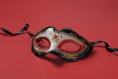 Photo of One beautiful carnival mask on red background