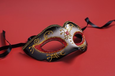 Photo of One beautiful carnival mask on red background