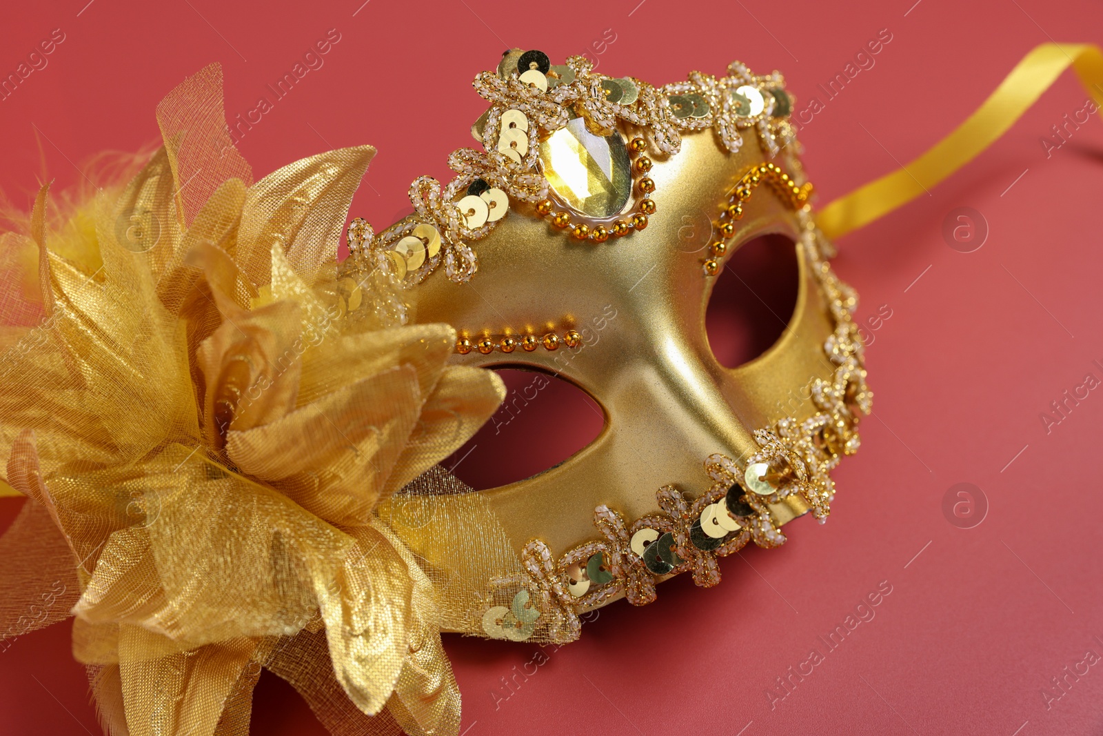 Photo of One beautiful carnival mask on red background