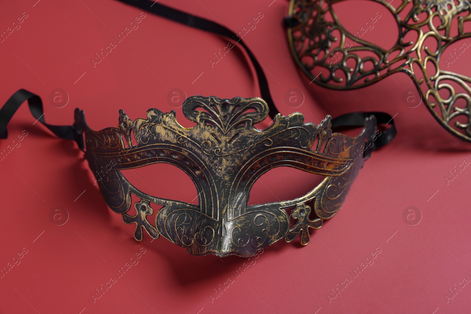 Photo of Two beautiful carnival masks on red background