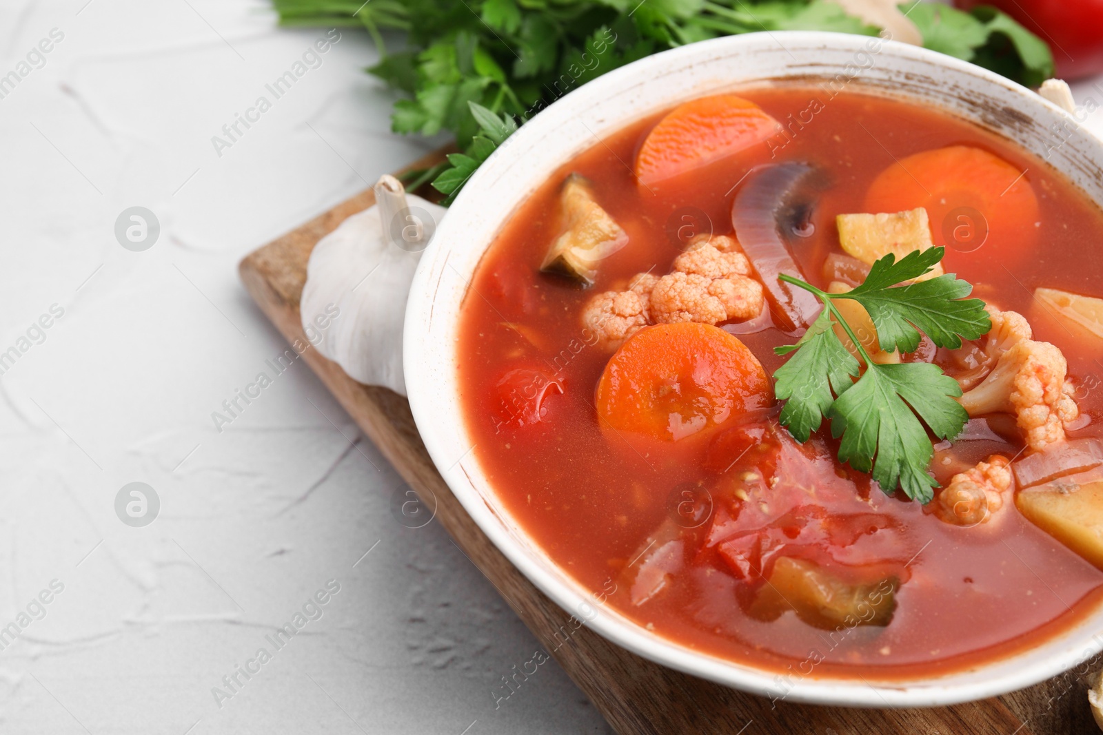 Photo of Delicious homemade stew in bowl on light table, closeup