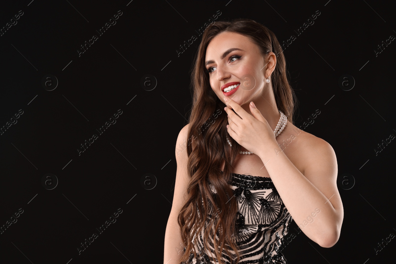 Photo of Portrait of smiling woman on black background. Space for text