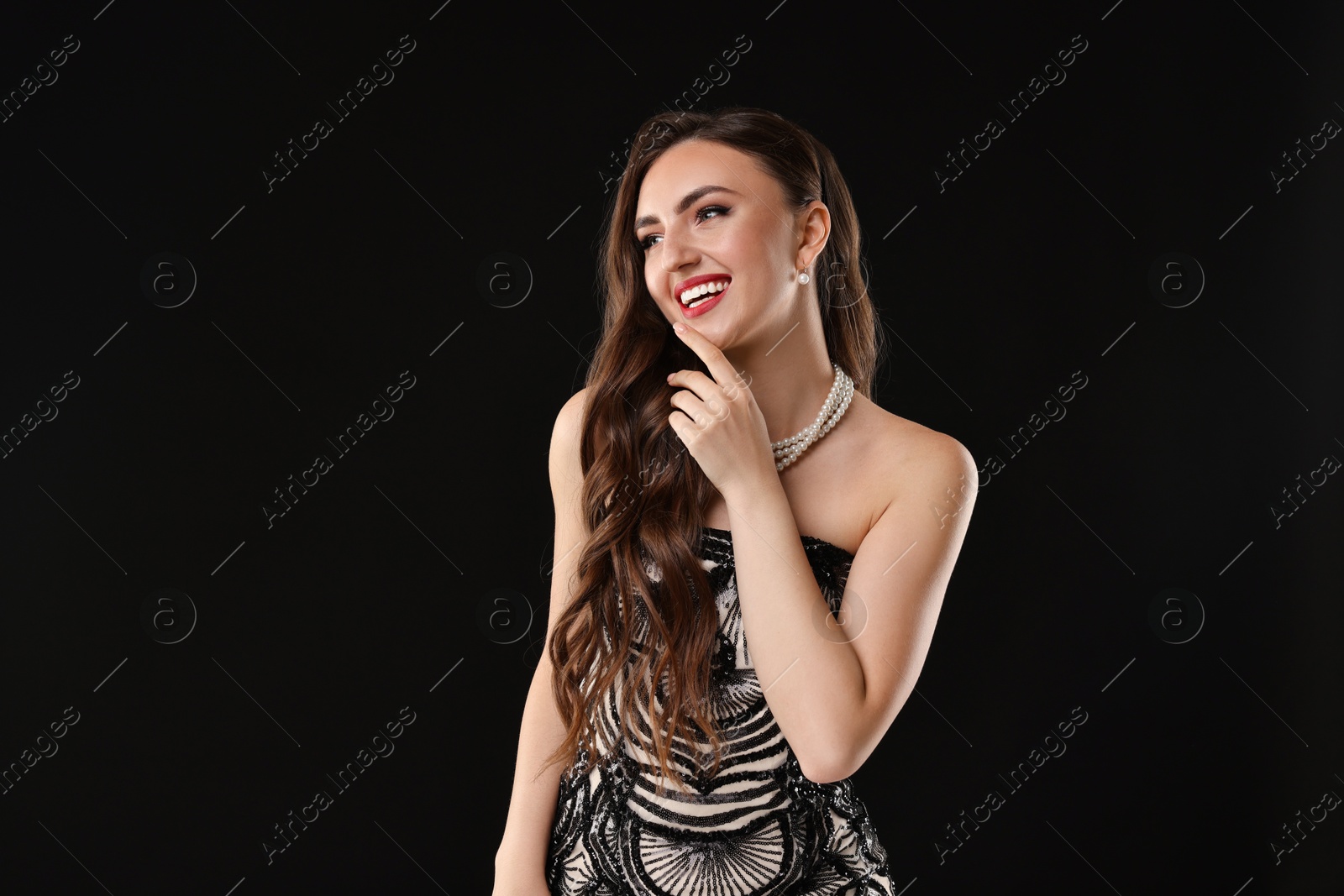 Photo of Portrait of smiling woman on black background