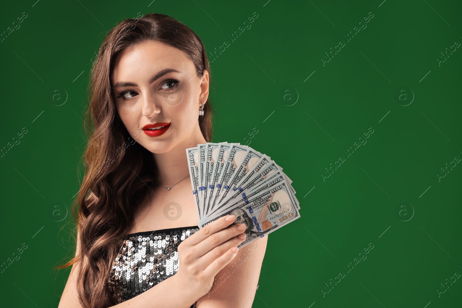 Photo of Charming woman with dollar banknotes on green background. Space for text