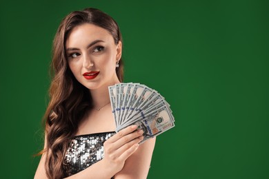 Charming woman with dollar banknotes on green background. Space for text