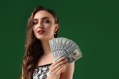 Charming woman with dollar banknotes on green background. Space for text