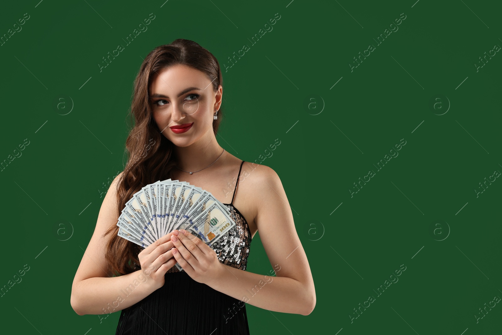 Photo of Charming woman with dollar banknotes on green background. Space for text