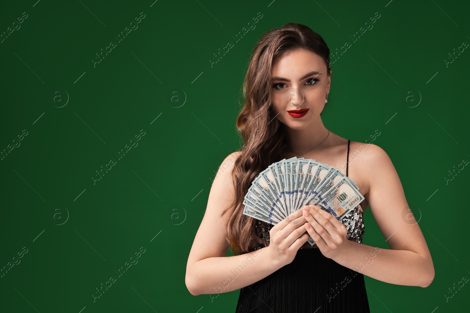 Photo of Charming woman with dollar banknotes on green background. Space for text