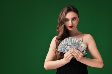 Charming woman with dollar banknotes on green background. Space for text