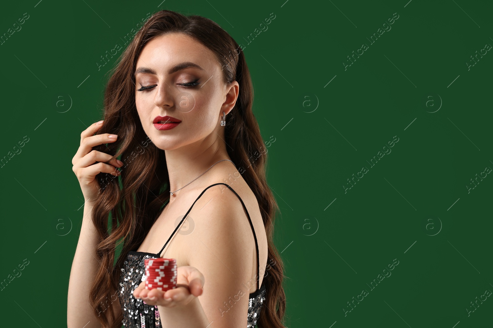 Photo of Charming woman with poker chips on green background. Space for text