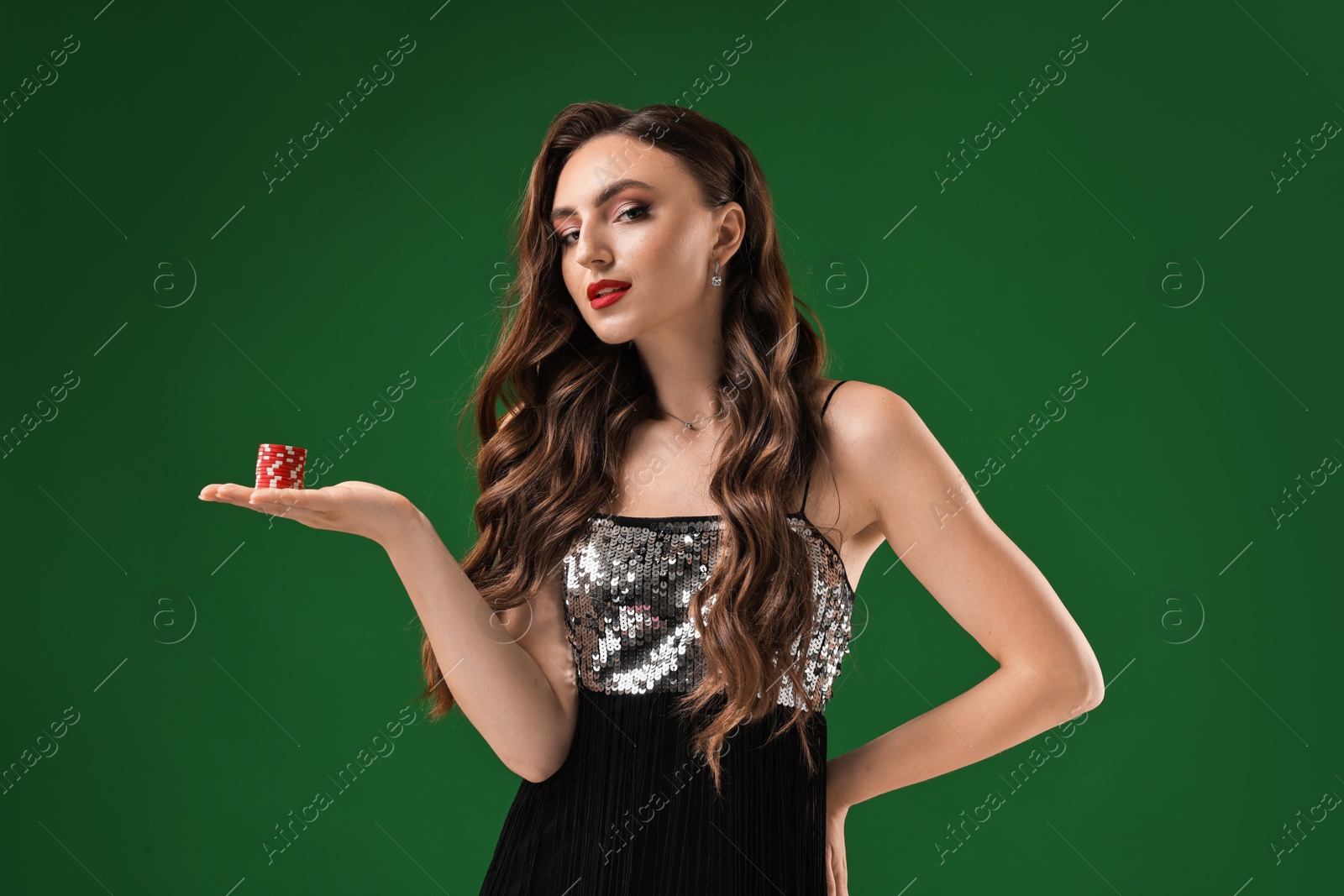 Photo of Charming woman with poker chips on green background