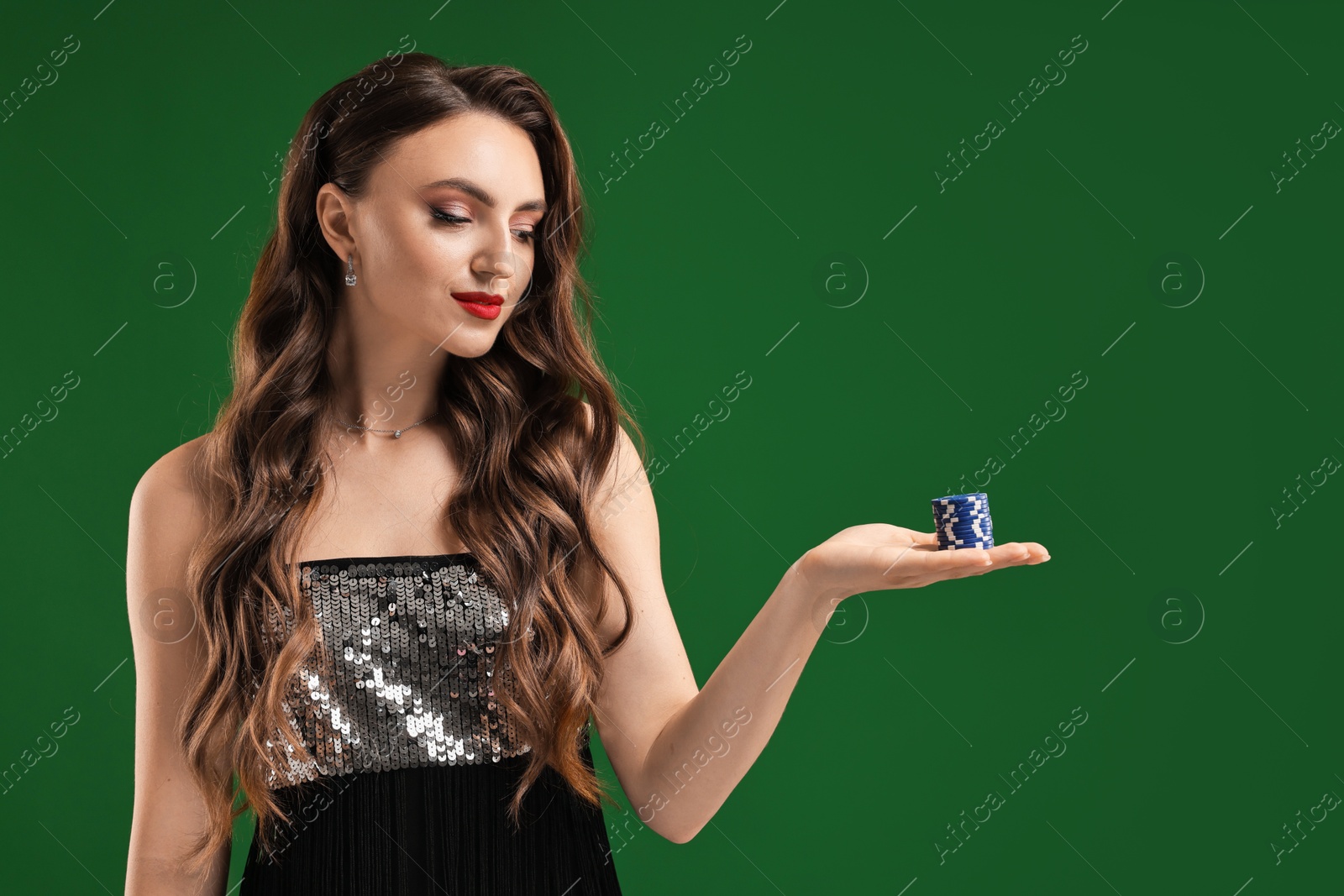 Photo of Charming woman with poker chips on green background. Space for text