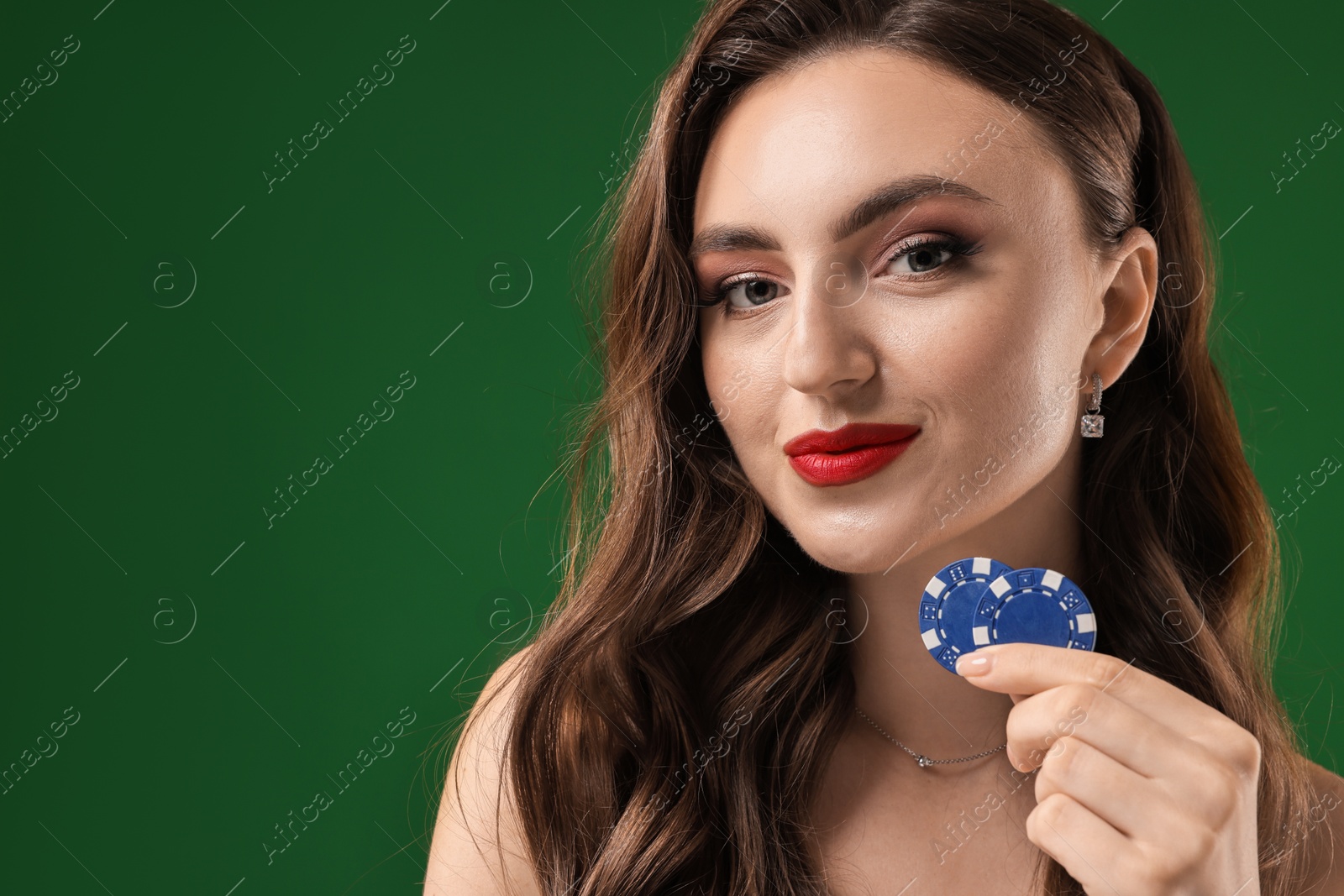 Photo of Charming woman with poker chips on green background. Space for text