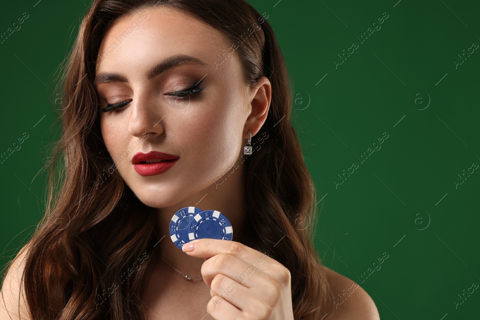 Photo of Charming woman with poker chips on green background. Space for text