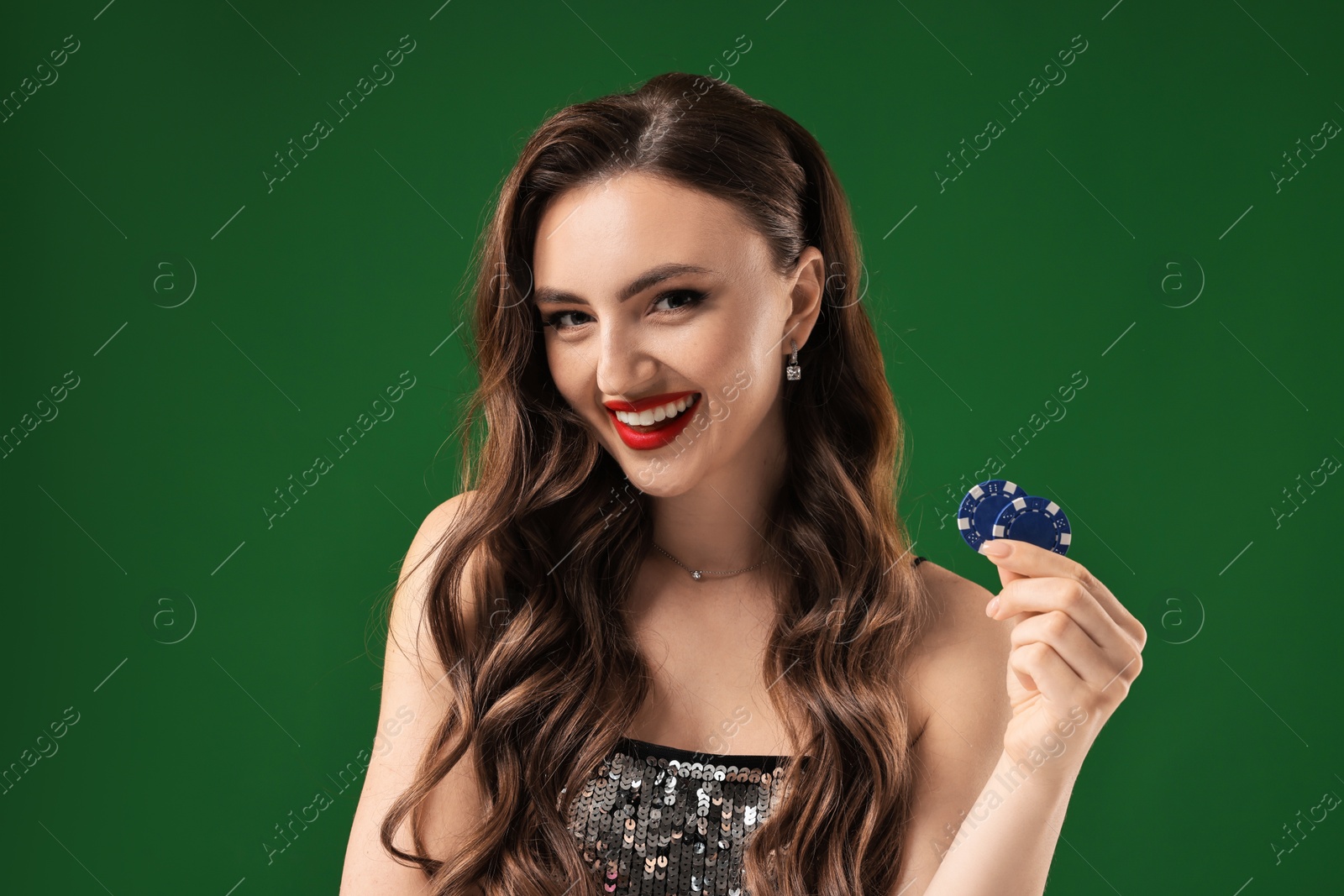 Photo of Smiling woman with poker chips on green background