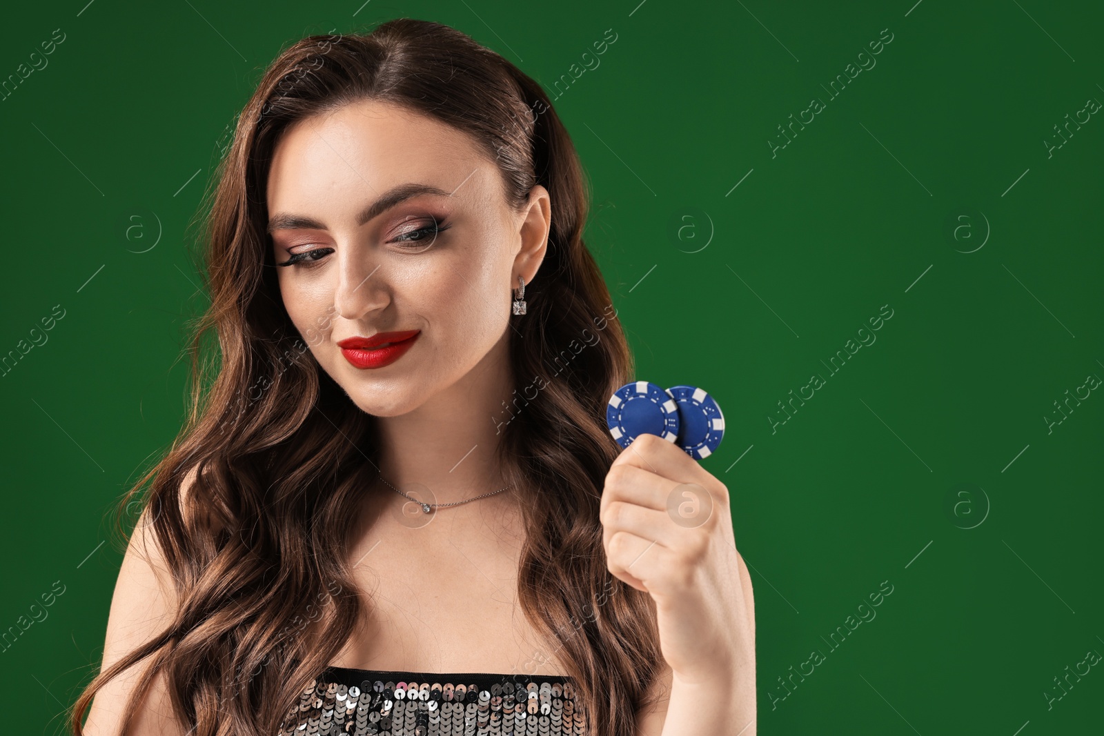 Photo of Charming woman with poker chips on green background. Space for text