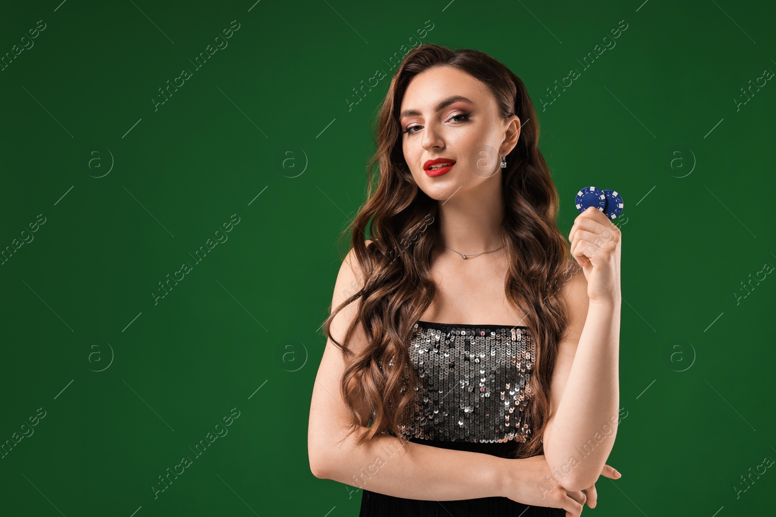 Photo of Charming woman with poker chips on green background. Space for text