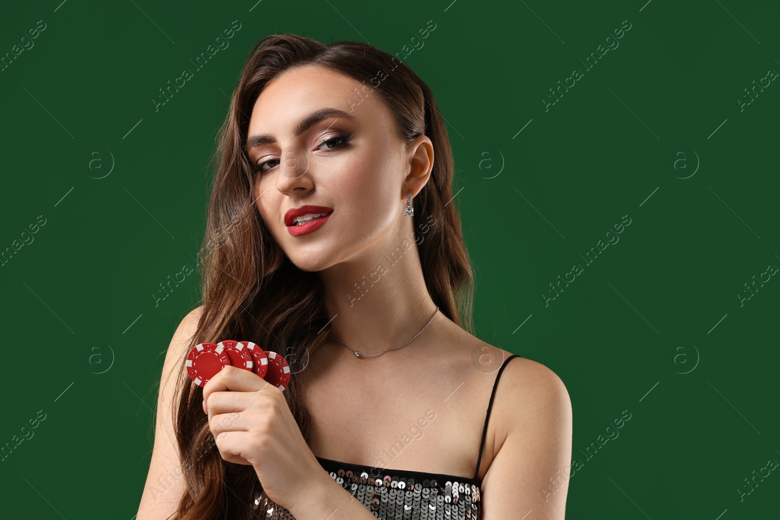 Photo of Charming woman with poker chips on green background. Space for text